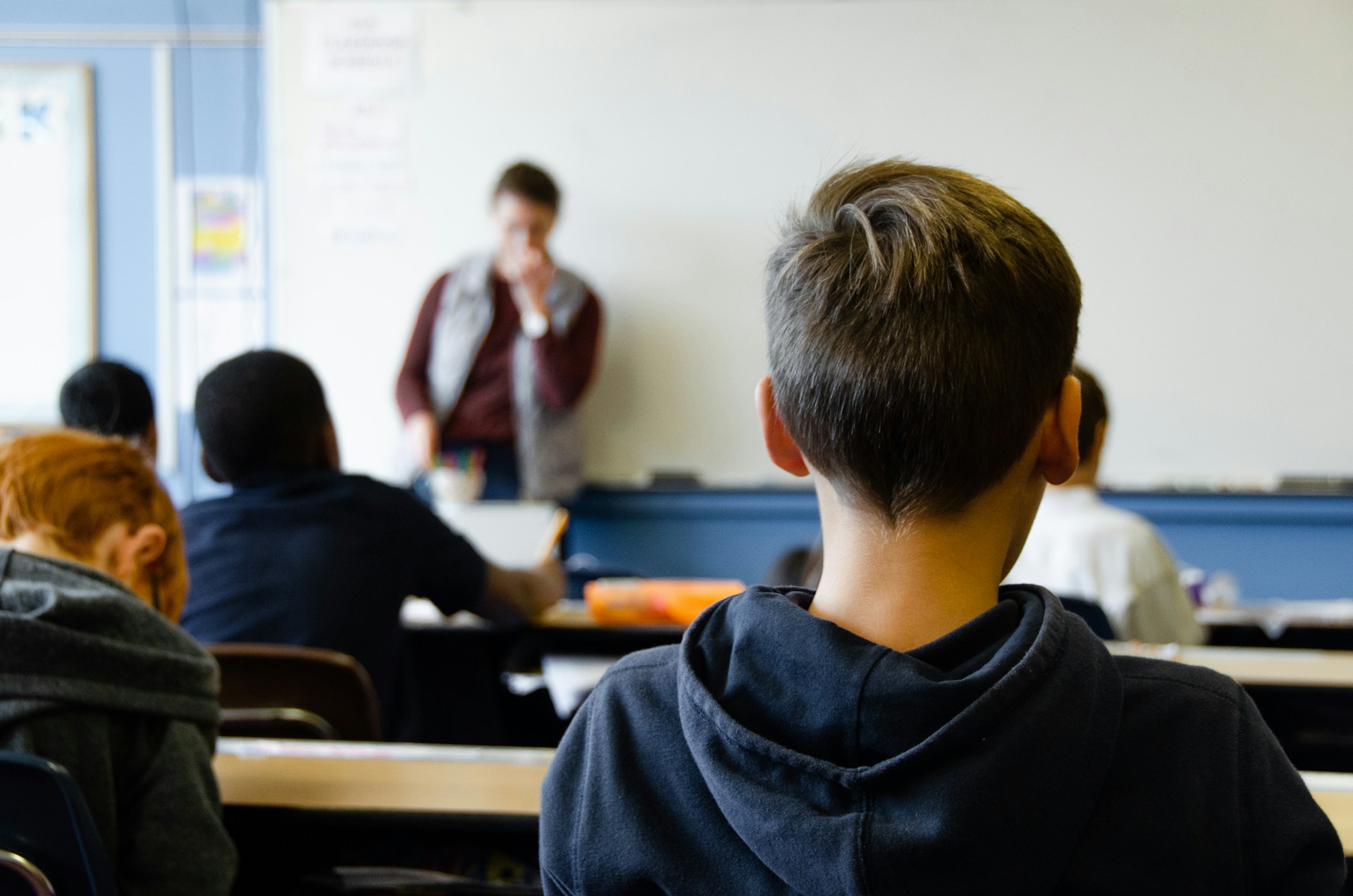 school classroom environment with the back of a young boy's head