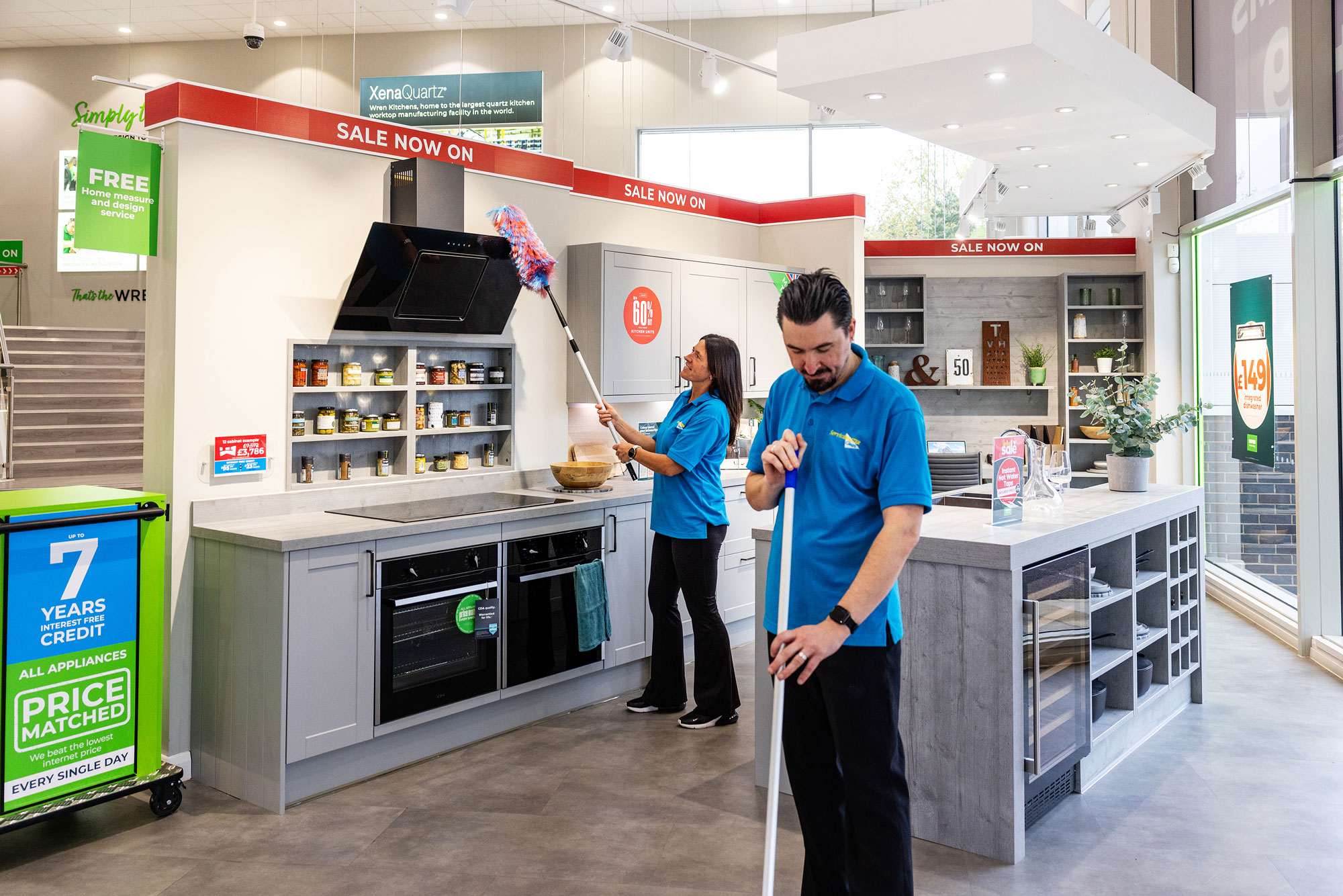 woman and male cleaner cleaning a kitchen showroom