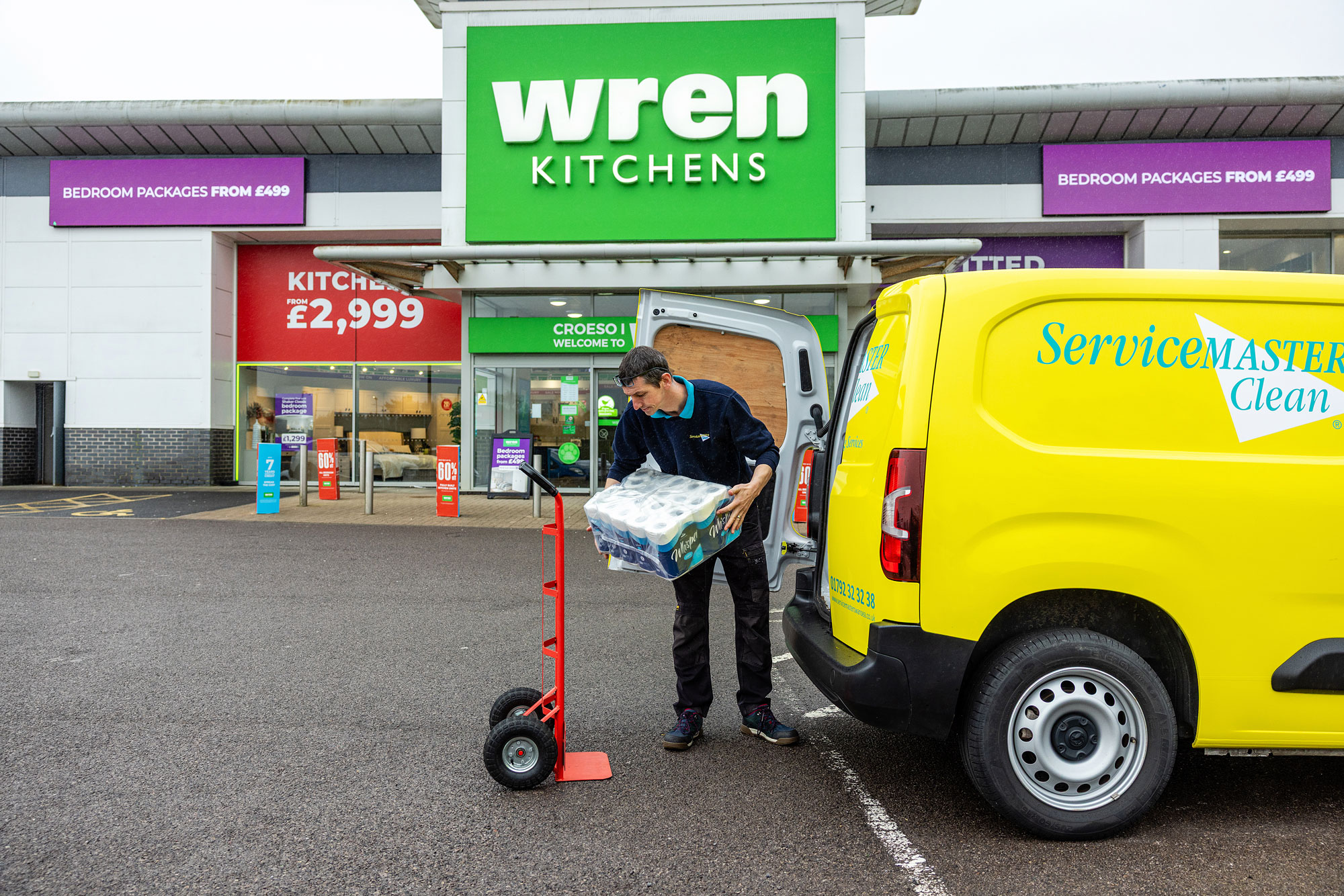 Male cleaning unloading servicemaster van